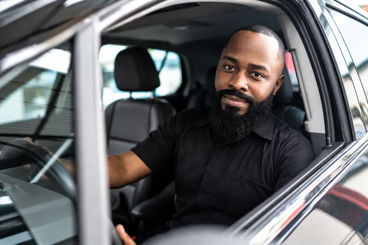 A driver smiling from behind the wheel